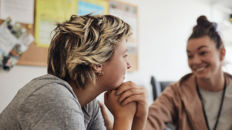 Two women engrossed in discussion at a table.