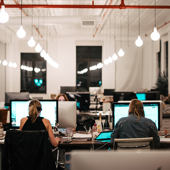 I colleghi lavorano al computer in un moderno ambiente