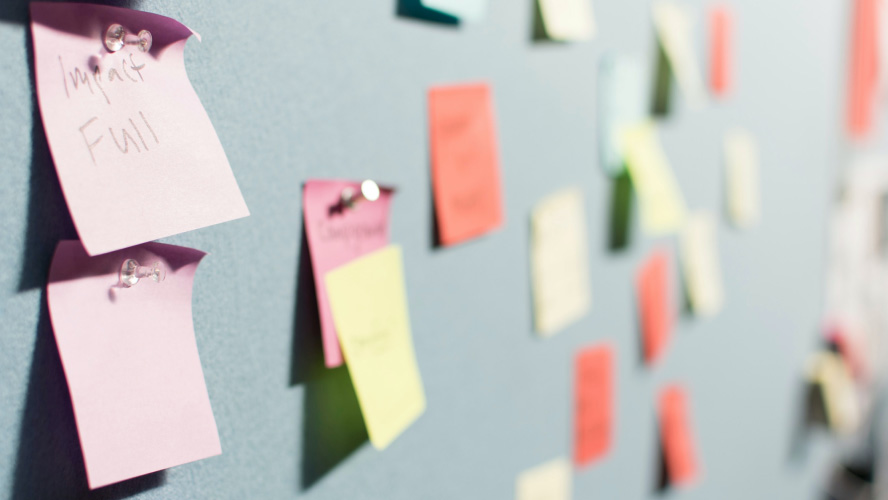 Colorful post-it notes on a wall for organizing ideas and tasks.